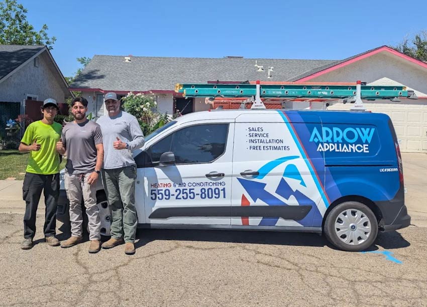 hree Arrow Appliance HVAC technicians giving a thumbs up next to a branded service van parked in front of a residential home
