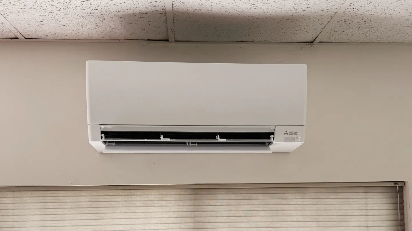 Front view of an open air-flow louver on a wall-mounted Mitsubishi Electric ductless indoor mini-split unit.